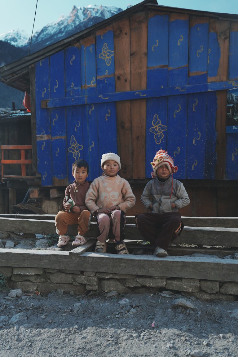 Children outside a mountain lodge