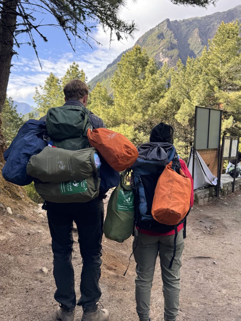 Volunteers carrying clean-up bags on the trail